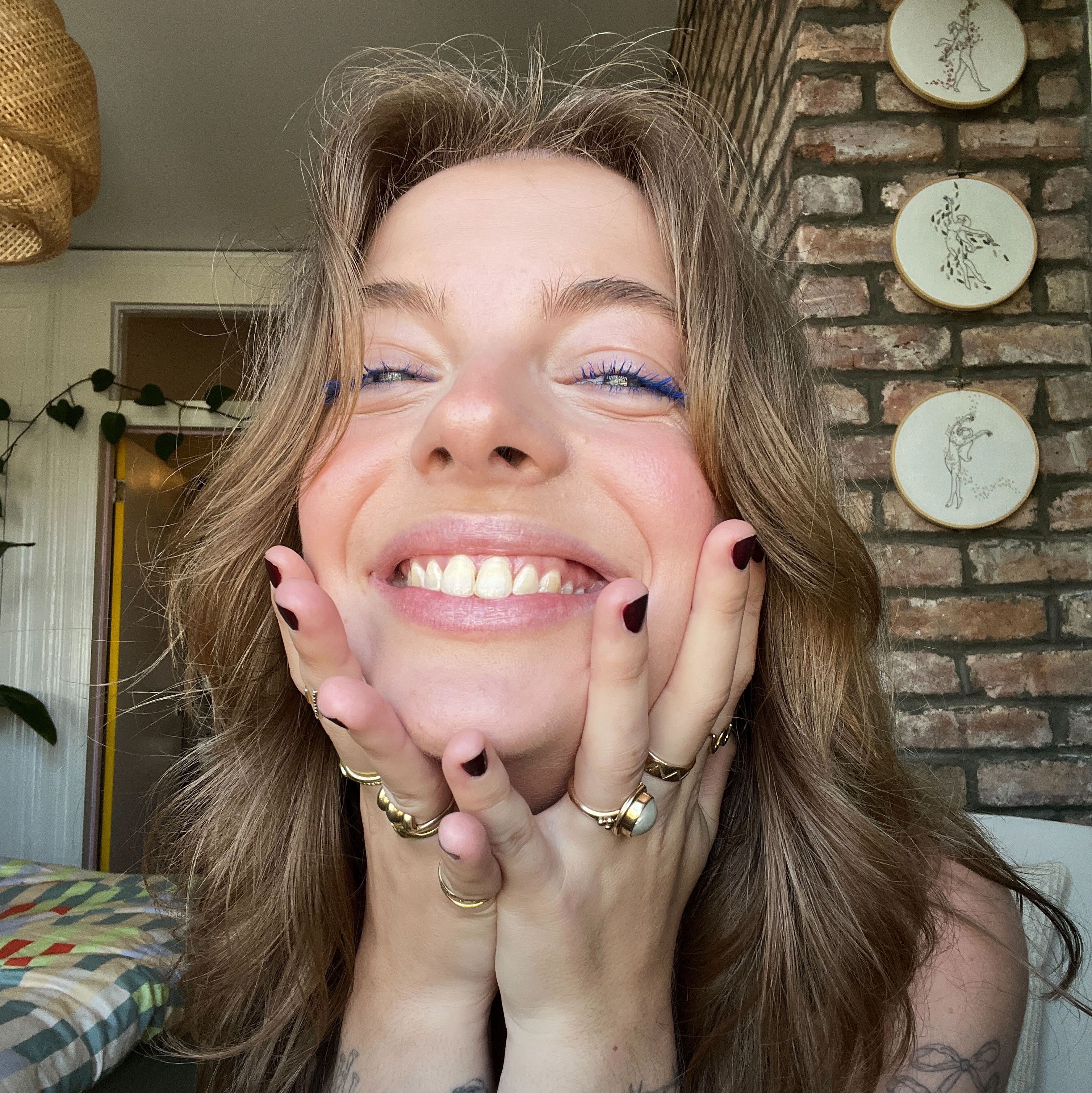 Nina smiles widely at the camera