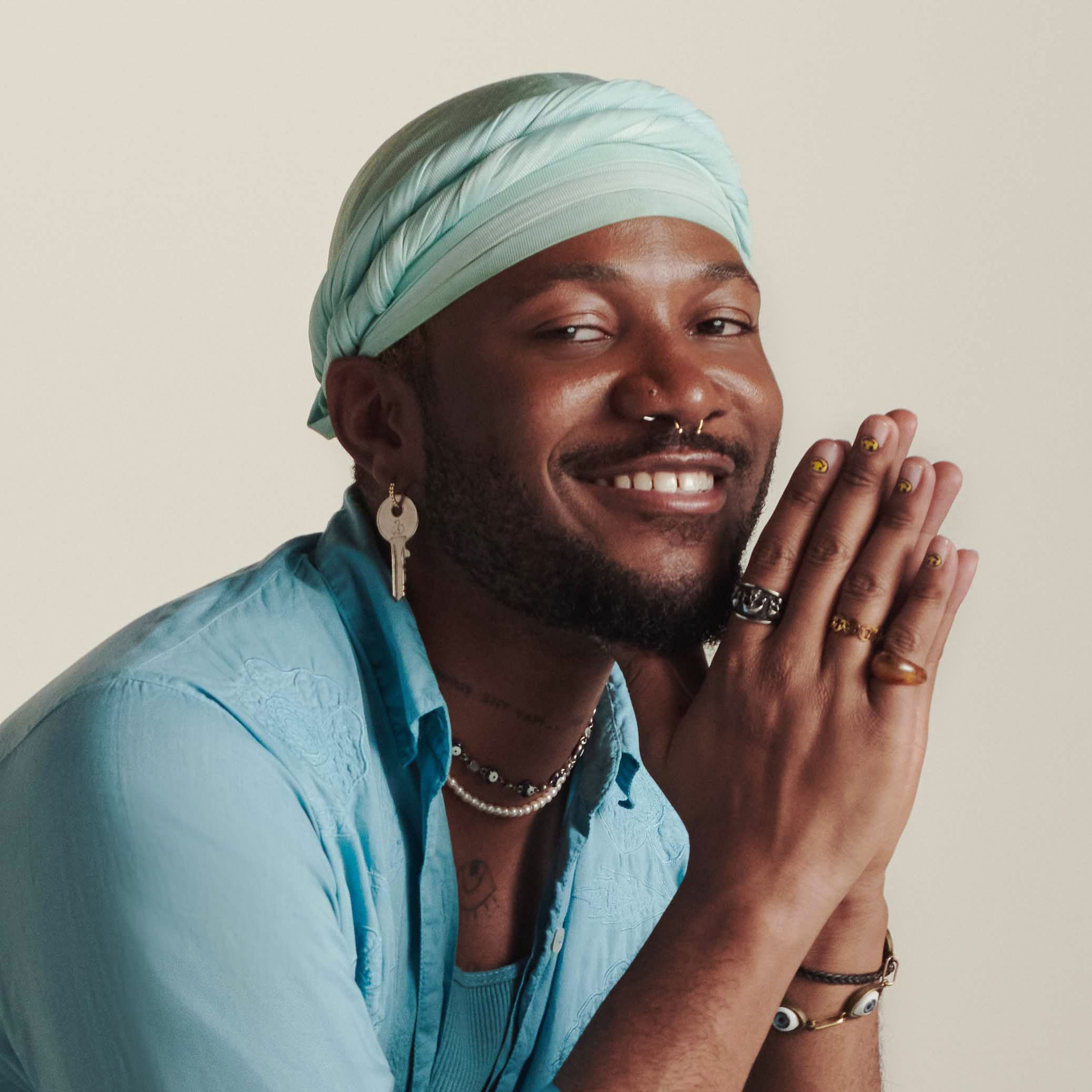 A portrait of Shahem leaning in and looking directly into camera. Their face feels serious but intentional.